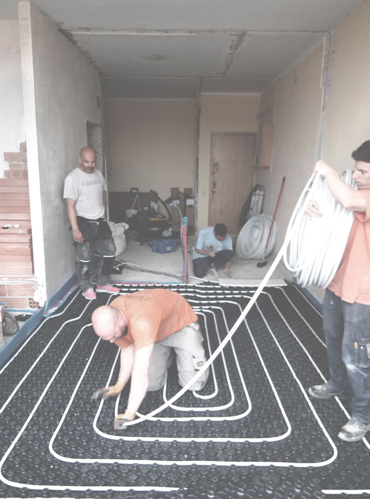 Operarios de TC-Interiors instalando un suelo radiante en Barcelona